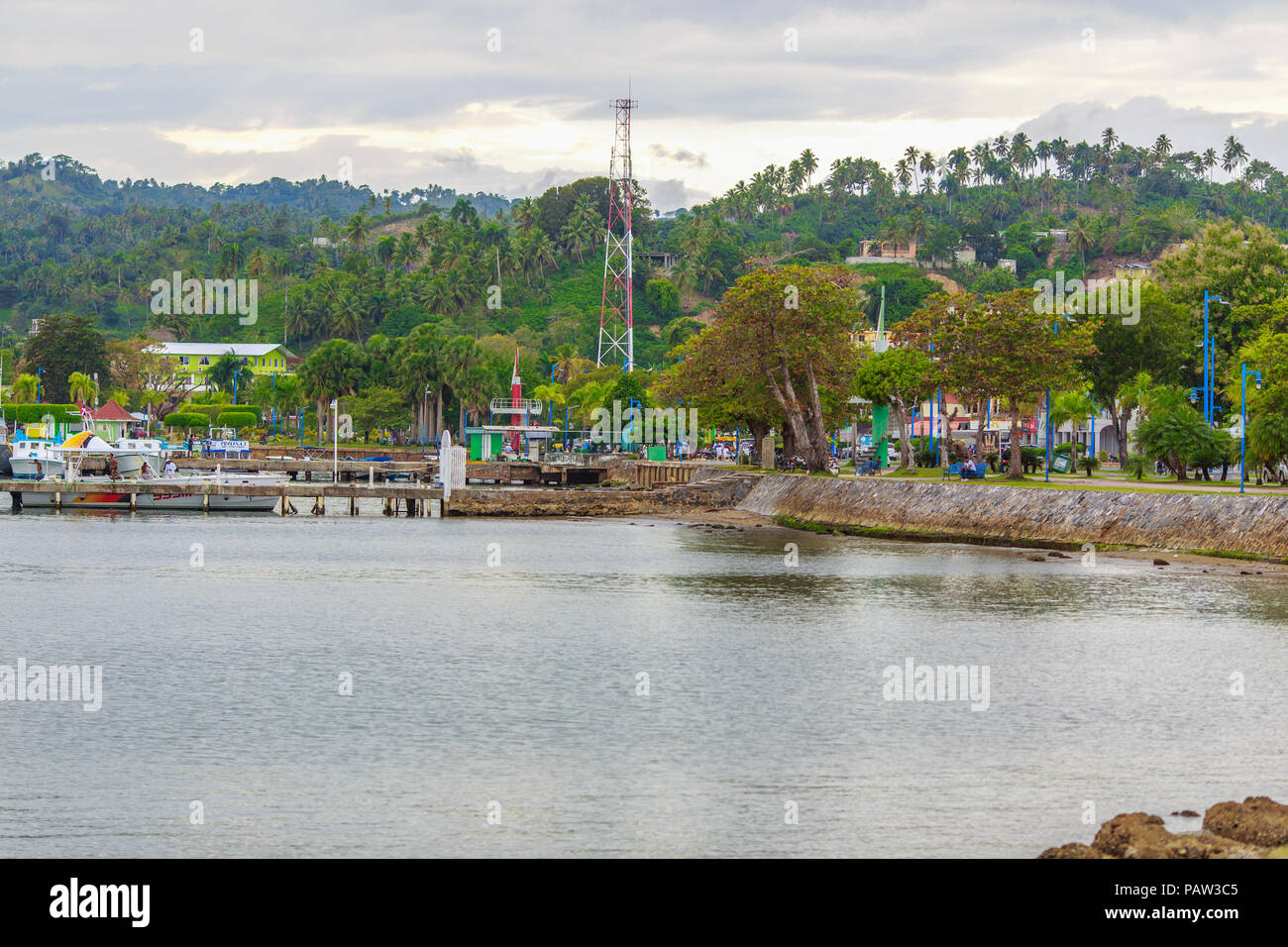 the view from the water on the embankment with green palm trees. Samana, Dominican Republic Stock Photo