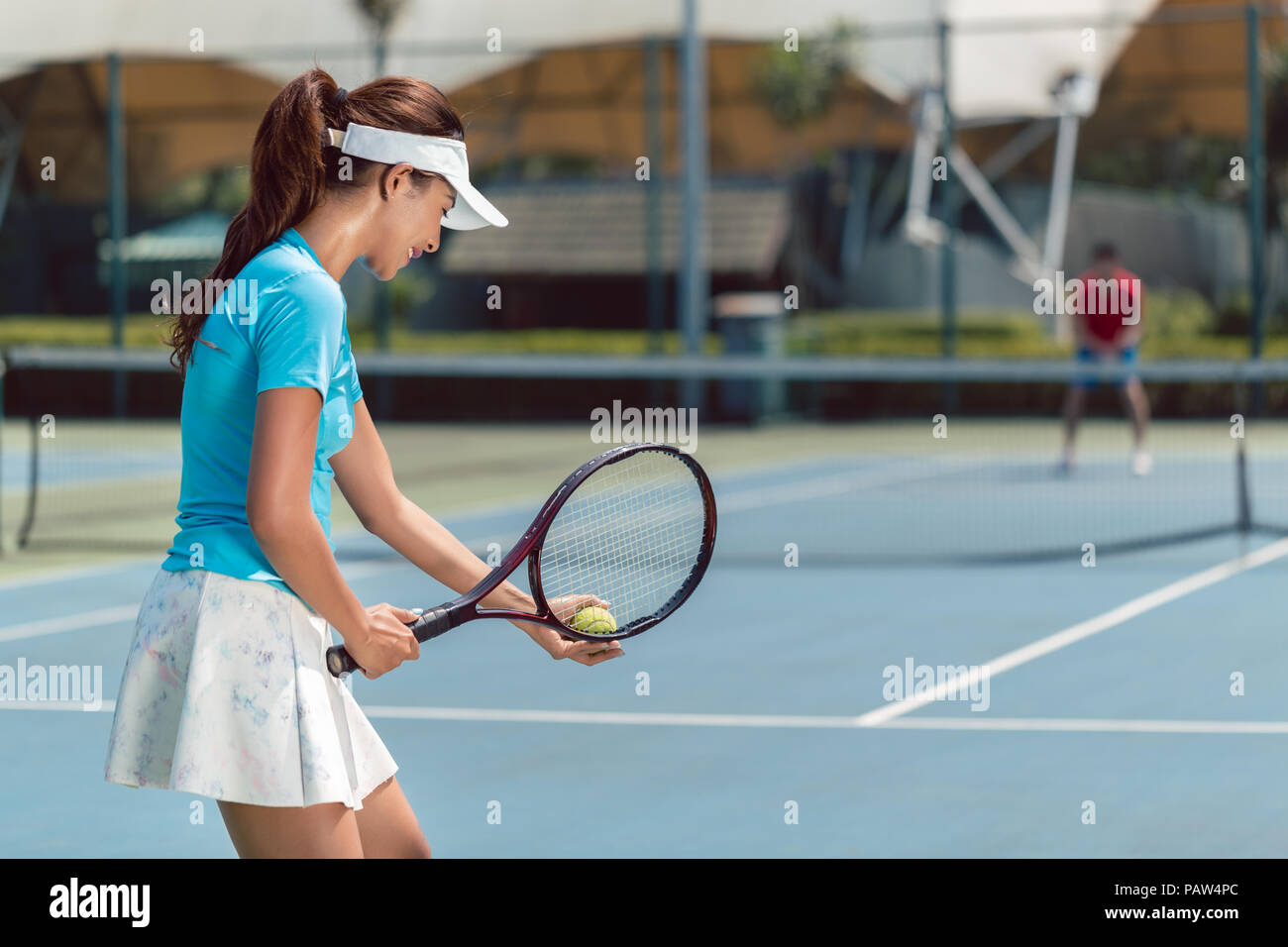 Beautiful and competitive woman smiling before starting the match Stock Photo