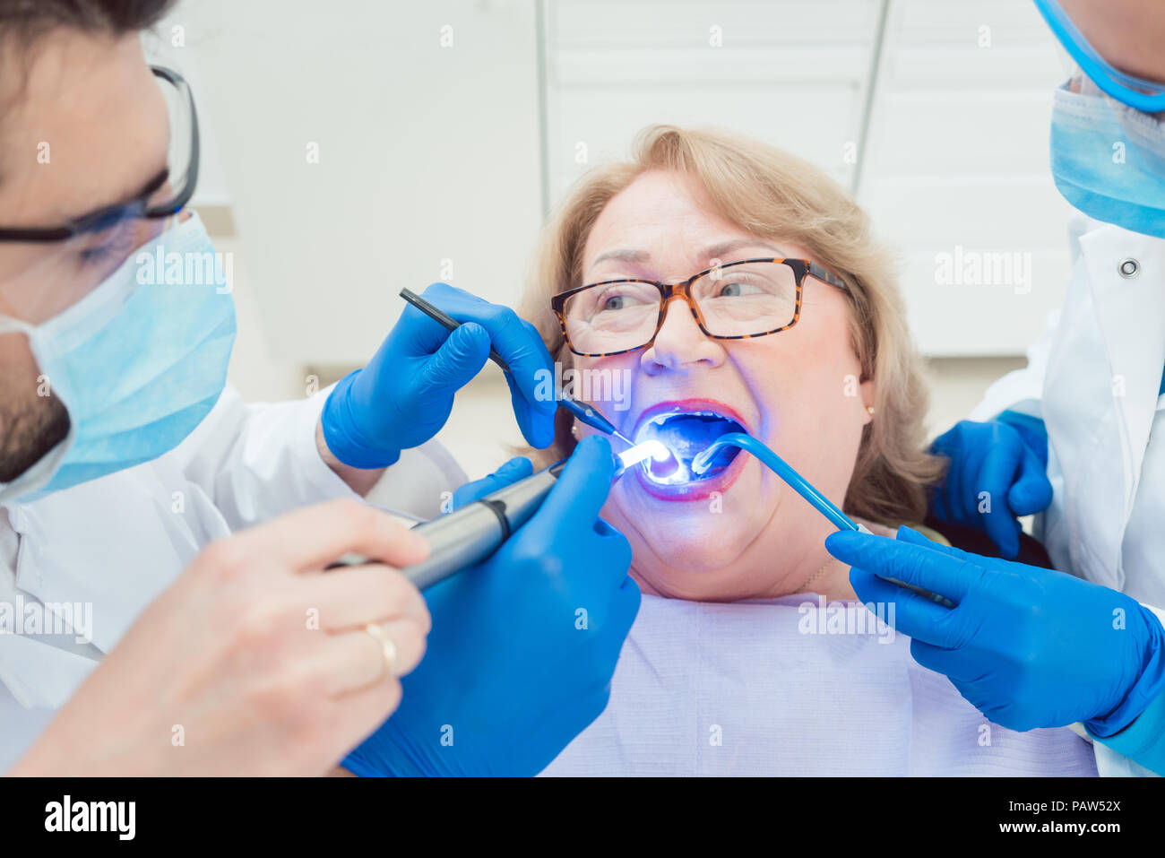 Dentists hardening toot crown with UV light  Stock Photo