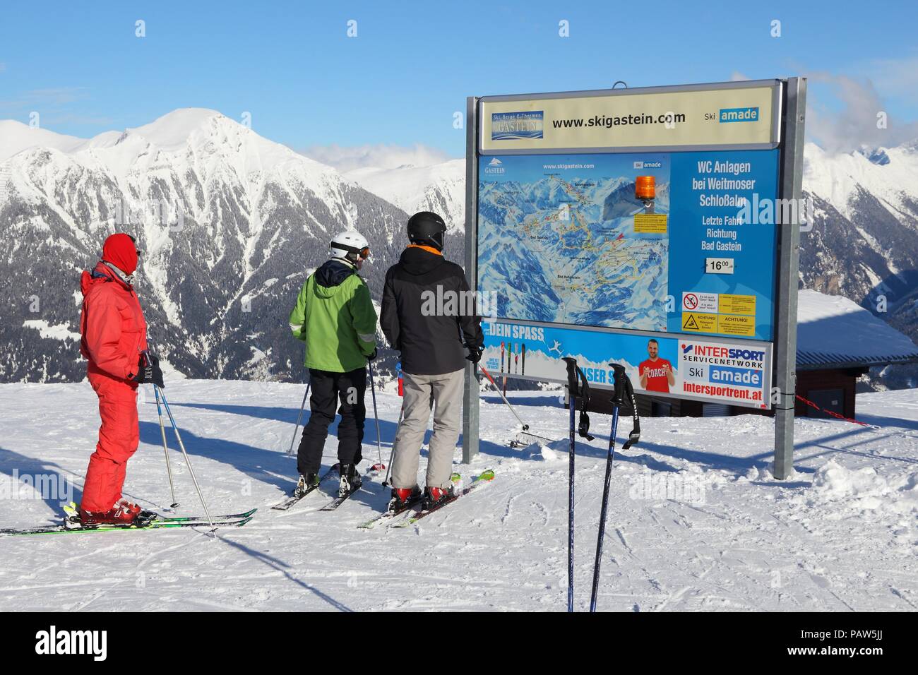 BAD HOFGASTEIN, AUSTRIA - MARCH 9, 2016: People analyze map in Bad Hofgastein. It is part of Ski Amade, one of largest ski regions in Europe with 760k Stock Photo