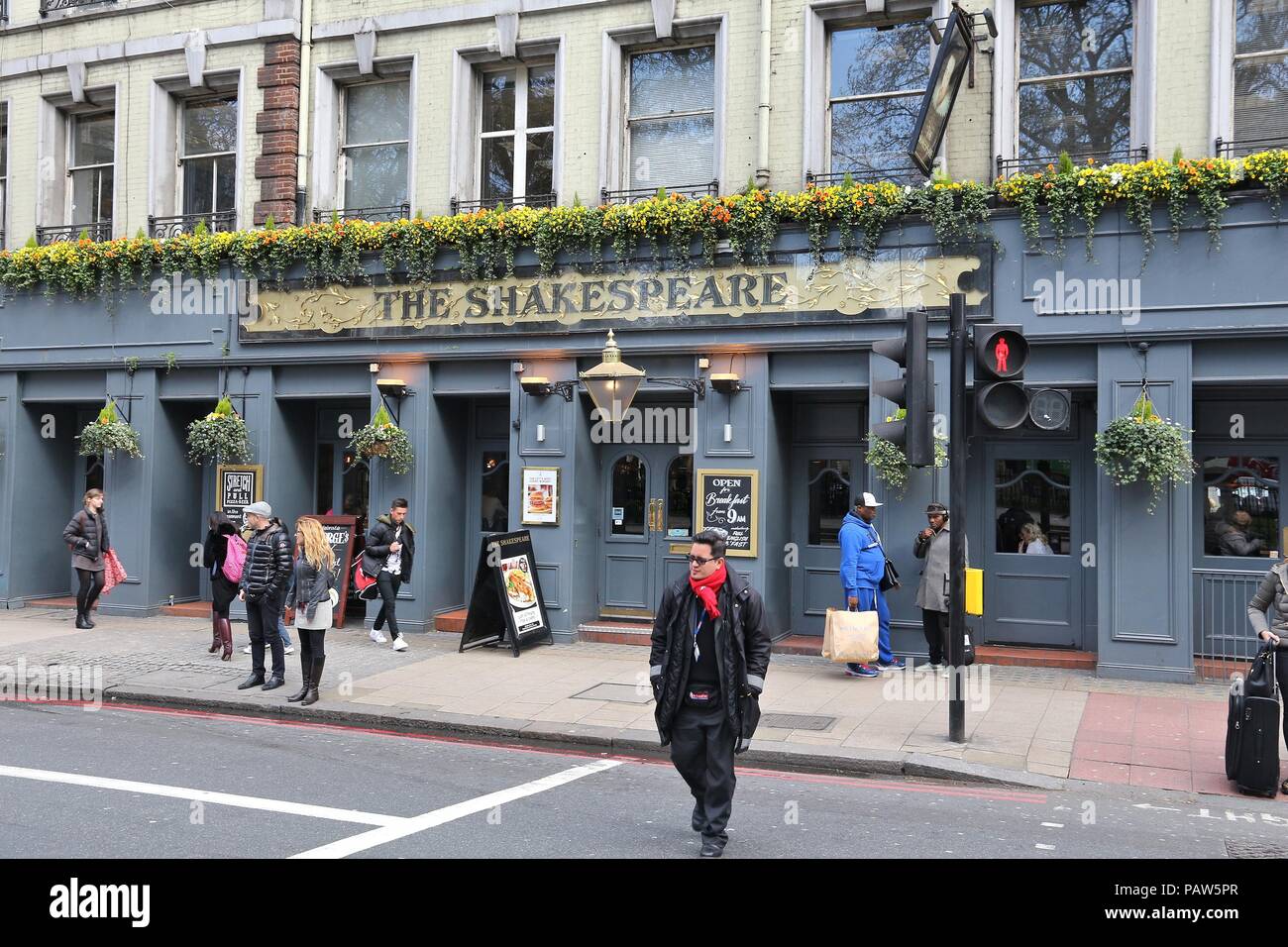 LONDON, UK - APRIL 23, 2012: People visit The Shakespeare pub in London. It is a typical London pub. There are more than 7,000 pubs in London. Stock Photo