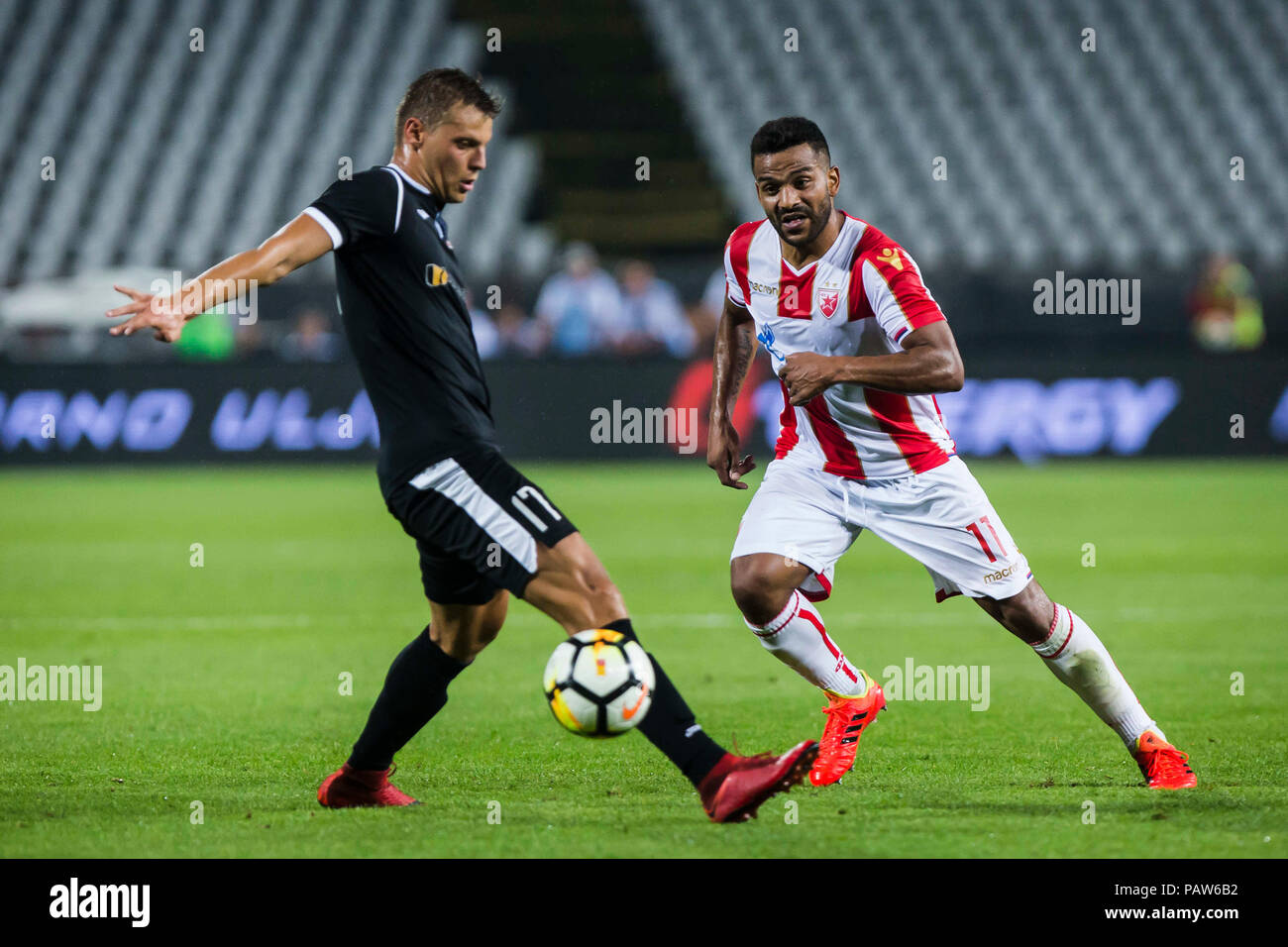 Belgrade, Serbia. 17th July, 2018. Crvena Zvezda's Lorenzo Ebecilio (L)  vies with Spartak's Vitor Silva Honorato during the first qualifying round  UEFA Champions League football match between Crvena Zvezda and Spartaks in