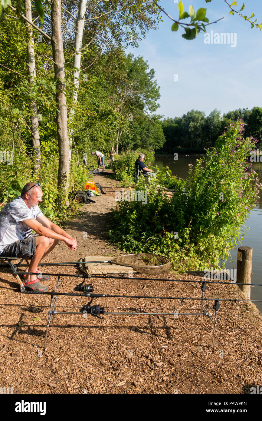 Henlow, Bedfordshire, UK, 25th July 2018. Angler Shaun tries to catch a few carp before the heat becomes too much for him and the fish stop biting. Credit: Mick Flynn/Alamy Live News Stock Photo