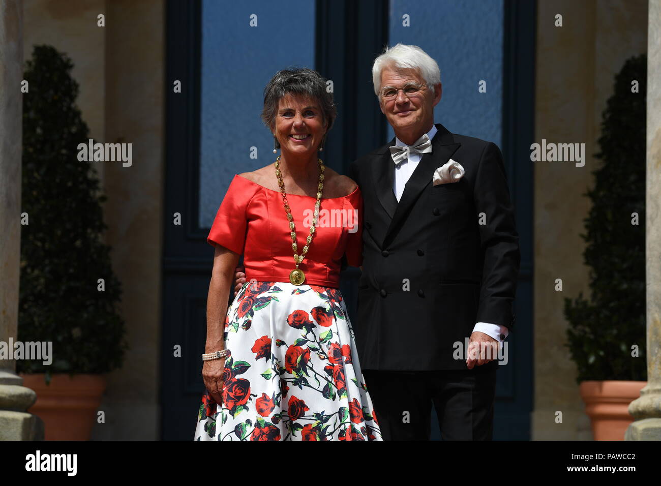 Germany, Bayreuth. 25th July, 2018. Brigitte Merk-Erbe, mayor of Bayreuth and her husband Thomas arrive for the premiere at the Festspielhaus. The Richard Wagner Festival 2018 will commence with a new rendition of 'Lohengrin'. Lovers of classical music from all over the world will head to Bayreuth between the 25th of July and the 29th of August in order to enjoy five long weeks of Wagner's opera pieces. Credit: Matthias Balk/dpa/Alamy Live News Stock Photo