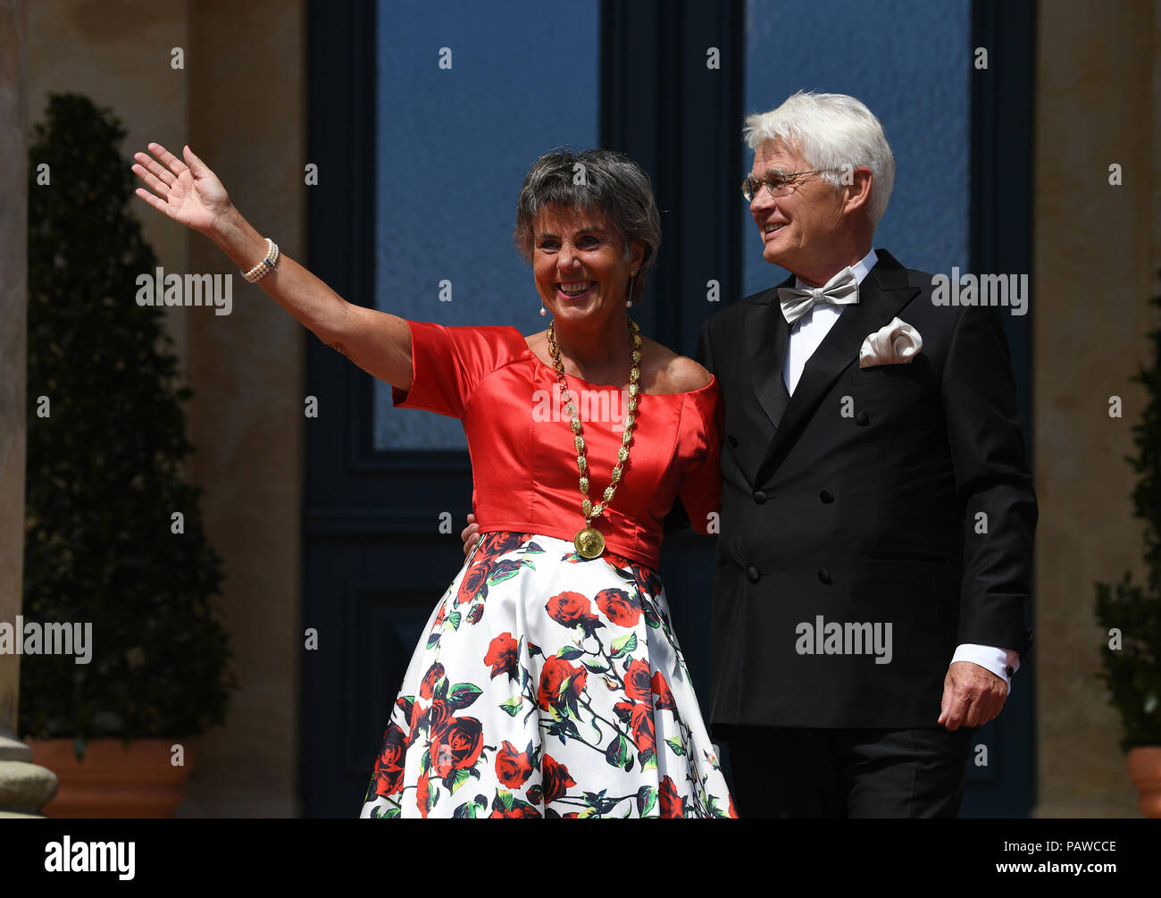 Germany, Bayreuth. 25th July, 2018. Brigitte Merk-Erbe, mayor of Bayreuth and her husband Thomas arrive for the premiere at the Festspielhaus. The Richard Wagner Festival 2018 will commence with a new rendition of 'Lohengrin'. Lovers of classical music from all over the world will head to Bayreuth between the 25th of July and the 29th of August in order to enjoy five long weeks of Wagner's opera pieces. Credit: Matthias Balk/dpa/Alamy Live News Stock Photo