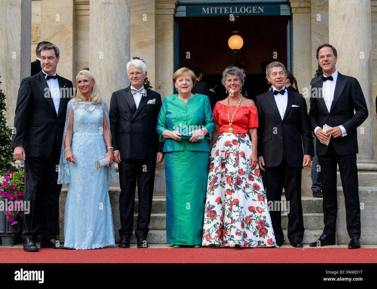 Bayreuth, Germany. 25th July, 2018. Bavarian Minister President Markus Soeder (CSU, l-r), his wife Karin, Thomas Erbe, husband of Bayreuth's mayor, German Chancellor Angela Merkel (CDU), Bayreuth's mayor Brigitte Merk-Erbe, Merkel's husband Joachim Sauer and Dutch Prime Minister Marc Rutte arrive at the festival hall. The Richard-Wagner-Festivals 2018 start with a new performance of Lohengrin'. From 25 July to 29 August, Wagner afficionados travel to the 'Green Hill' to experience the composer's operas. Credit: Matthias Balk/dpa/Alamy Live News Stock Photo