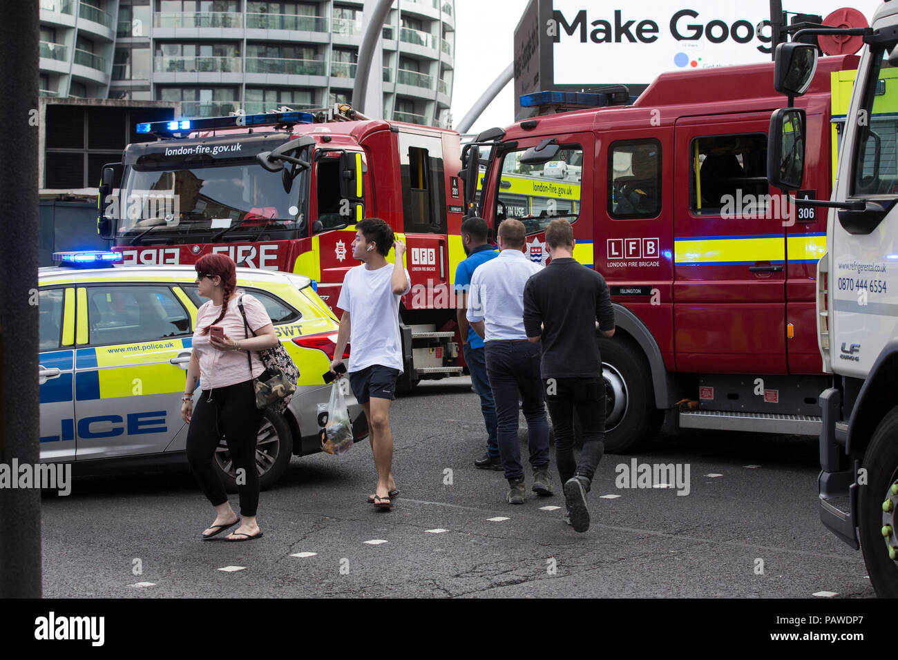 London, UK, 25 July 2018. Old Street Bike accident . 25.07.2018 Pedestrians cross the busy road after a cyclist collided with a concrete lorry on Old Street roundabout this afternoon. Credit: Clickpics/Alamy Live News Stock Photo