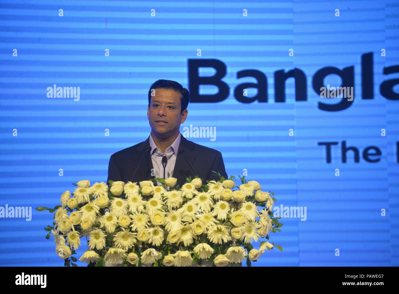 (180725) -- DHAKA, July 25, 2018 (Xinhua) -- Bangladeshi Prime Minister's ICT Affairs Adviser Sajeeb Wazed Joy delivers a speech at the Bangladesh 5G Summit 2018 in Dhaka, Bangladesh, on July 25, 2018. Chinese telecommunications giant Huawei conducted Bangladesh's first trial of fifth generation network (5G) teaming up with the Bangladeshi government's Posts & Telecommunications Division, the Ministry of Posts, Telecommunications and Information Technology and Robi, a joint venture of Axiata Group Berhad (Malaysia), Bharti Airtel Limited (India) and NTT DoCoMo Inc. (Japan), at a ceremony in th Stock Photo