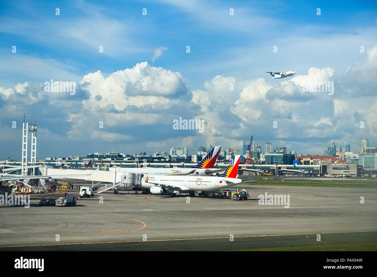 Manila NAIA Airport, Philippines - November 28, 2016: A Skyjet Plane Takes off, with a few Philippine Airlines planes unloading on the tarmac below. Stock Photo