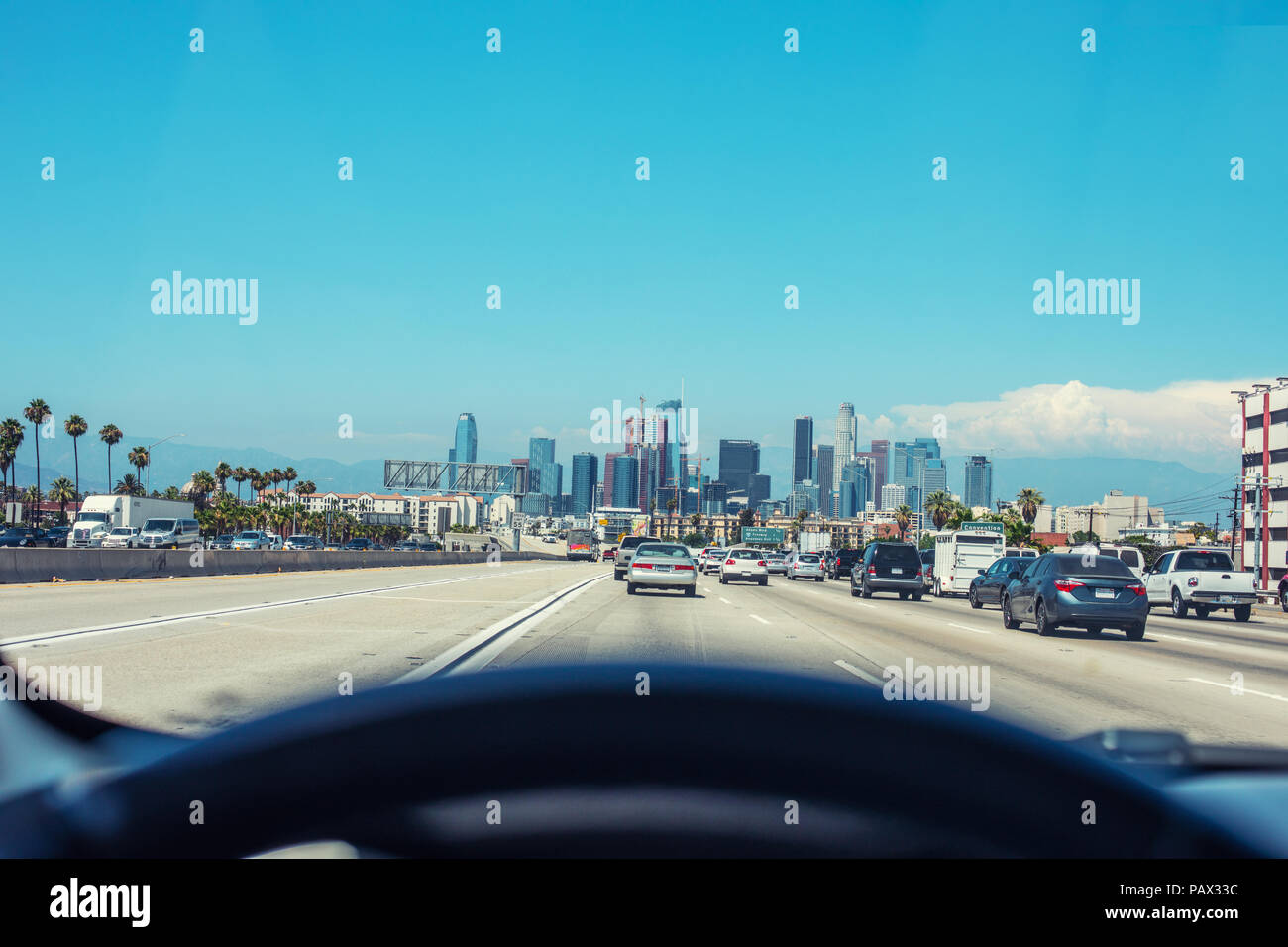 Driving in a car towards Downtown Los Angeles. Big copy space for a