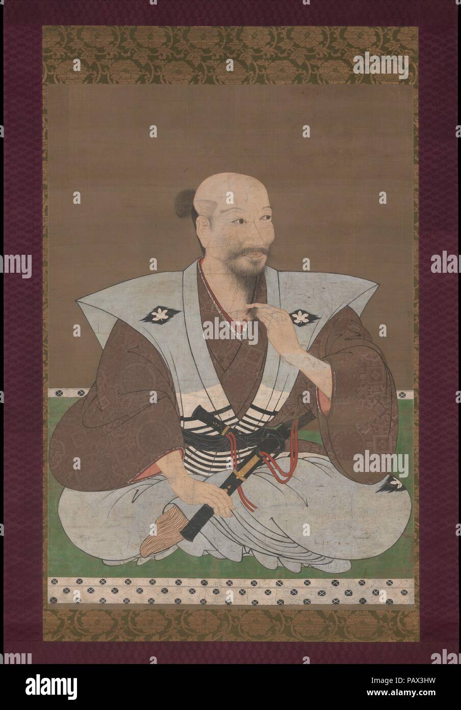Portrait of a Warrior. Artist: Unidentified Artist Japanese, late 16th century. Culture: Japan. Dimensions: Image: 47 13/16 x 33 9/16 in. (121.4 x 85.2 cm)  Overall with mounting: 86 3/4 x 41 5/8 in. (220.3 x 105.7 cm)  Overall with knobs: 86 3/4 x 45 1/8 in. (220.3 x 114.6 cm). Date: late 16th century.  This newly discovered painting depicting an unidentified warrior is executed at a size usually reserved for portraits of emperors and shoguns, and it ranks among the largest and finest secular portraits from Japan. Although the family crest of wild orange is associated with the Shibata family  Stock Photo