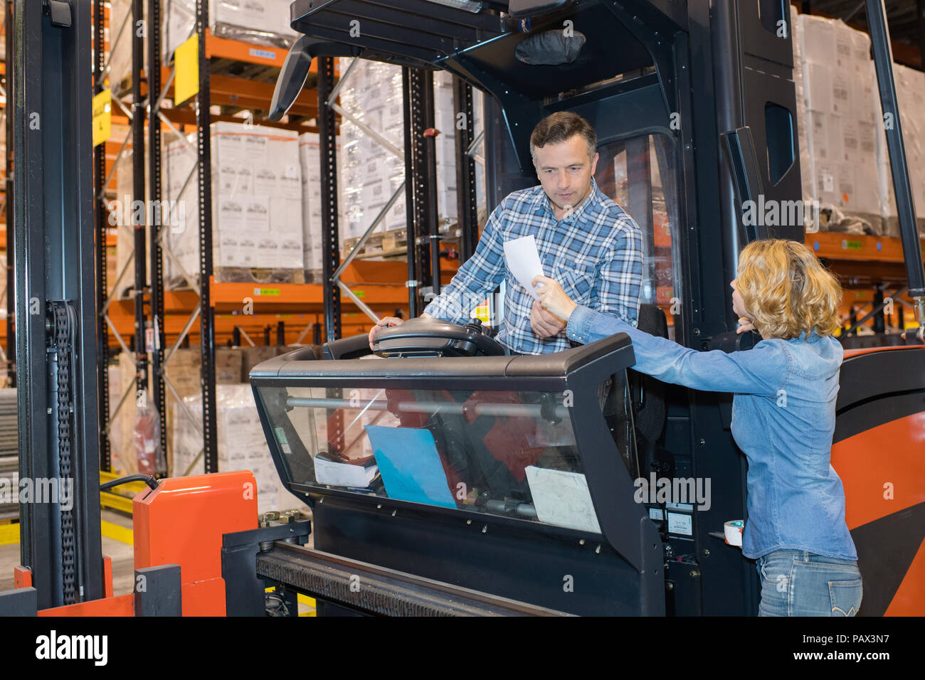 warehouse manager checking her inventory in a large warehouse Stock Photo