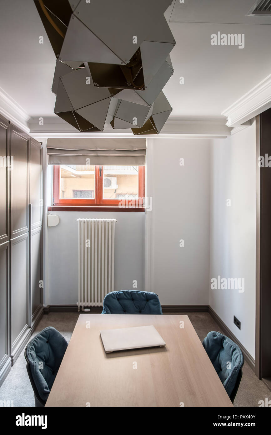 Small Meeting Room With White Walls And A Gray Floor There