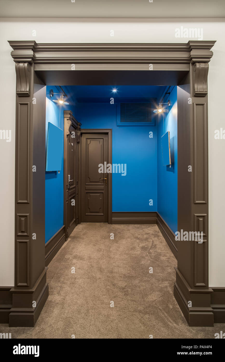 Bright corridor in a hotel with blue and white walls and a beige carpet on the floor. There are two brown entrance doors to the rooms, luminous lamps Stock Photo - Alamy Bright corridor in a hotel with blue and white walls and a beige carpet on the floor. There are two brown entrance doors to the rooms, luminous lamps Stock Photo - Alamy