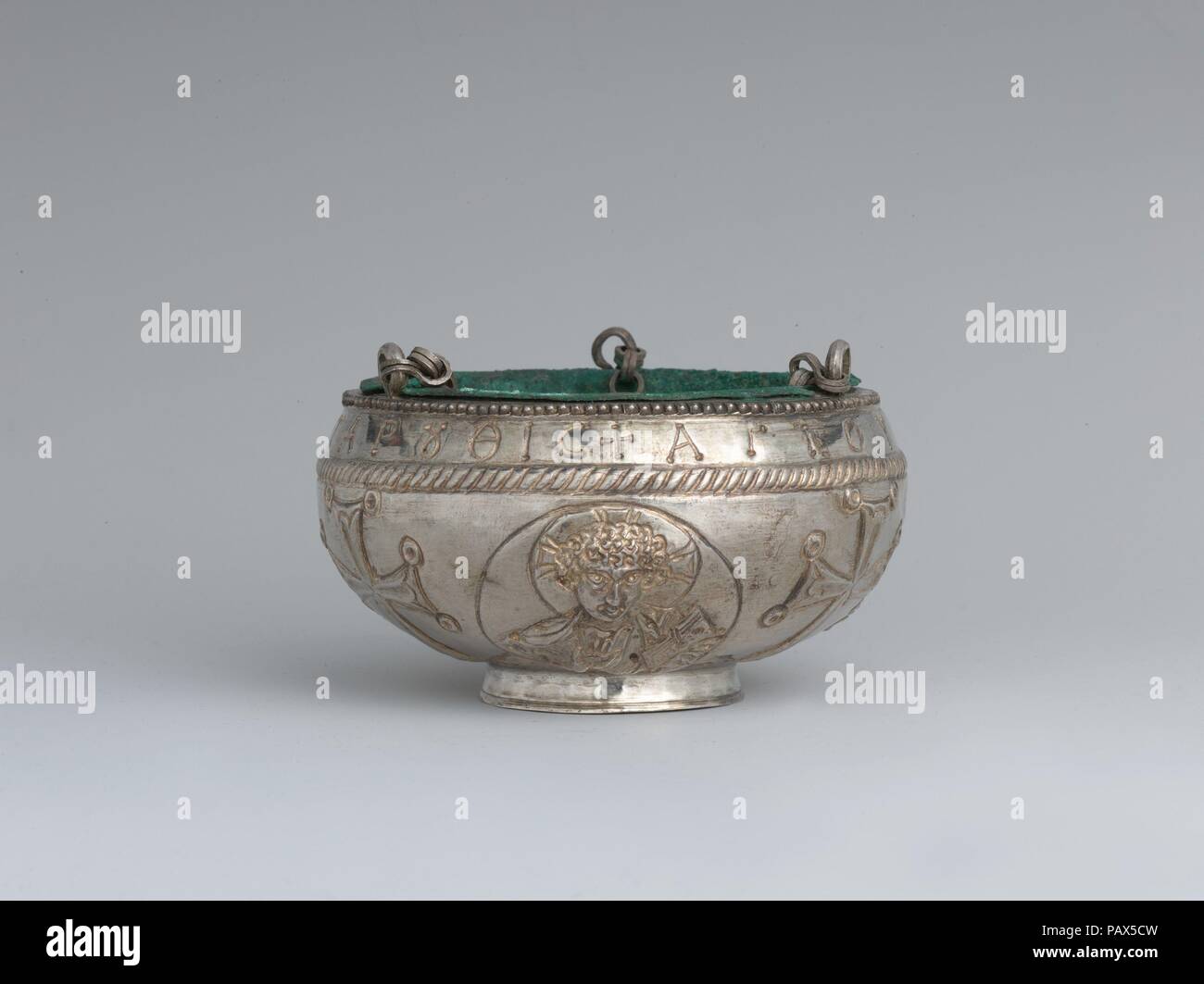The Attarouthi Treasure - Censer. Culture: Byzantine. Dimensions: Overall (without chain): 3 1/4 x 5 3/16 in. (8.2 x 13.2 cm)  Overall (hanging with chain): 15 1/16 x 5 3/16 in. (38.2 x 13.2 cm)  Diam. of foot: 2 5/16 in. (5.9 cm). Date: 500-650.  With a youthful Christ with a cruciform halo, two archangels, and crosses  Inscribed in Greek: Of Saint John of the village of Attaroutha  In early images of Christ he is always shown as a youth with short, curly hair. His halo is cruciform with three arms to represent the cross upon which he died. The flanking medallions containing archangels, the g Stock Photo