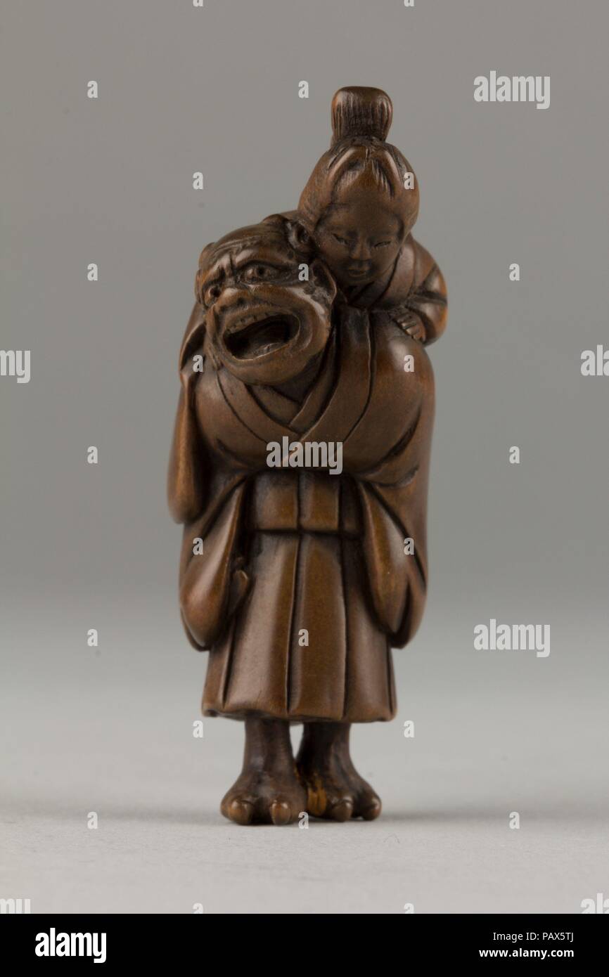 Netsuke of Demon Carrying a Woman on His Shoulders. Culture: Japan. Dimensions: H. 2 3/8 in. (6 cm); W. 7/8 in. (2.2 cm); D. 1 in. (2.5 cm). Date: 19th century. Museum: Metropolitan Museum of Art, New York, USA. Stock Photo