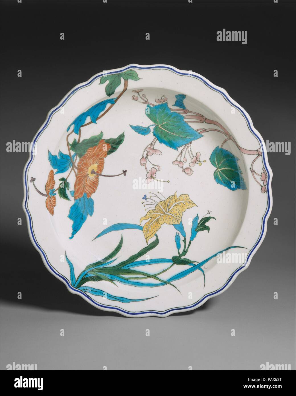 Dish. Culture: French, Paris. Dimensions: Diameter: 16 in. (40.6 cm). Maker: Joseph-Théodore Deck (French, Guebwiller, Alsace 1823-1891 Paris). Date: 1866.  Determined that pottery vessels should be regarded as true works of art, avant-garde ceramicists in France in the last decades of the nineteenth century transformed their craft into an intellectual and emotional endeavor. The pioneers of this revival were Jean Carriès, Ernest Chaplet, Théodore Deck, and Auguste Delaherche. These revolutionary artist-potters embraced artisanal traditions while pursuing lost techniques through exhaustive exp Stock Photo