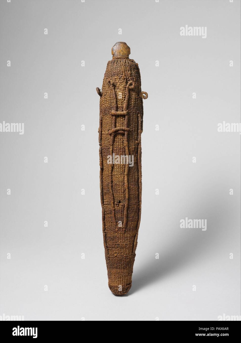 Image (To'o) representing the deity 'Oro. Culture: Maohi (Tahitian). Dimensions: H. 18 1/8 x Diam. 2 7/8 in. (46 x 7.3 cm). Date: 18th century.  Although human images in Polynesian sculpture are predominantly naturalistic, there are a number of instances in which the human form is taken almost to abstraction, for example, in images of the Tahitian war god 'Oro. Composed of a solid wooden core covered by intricately plaited layers of coconut fiber cordage, the images of 'Oro appear almost clublike, with the eyes, ears, and other facial features only lightly delineated in the outermost layer of  Stock Photo