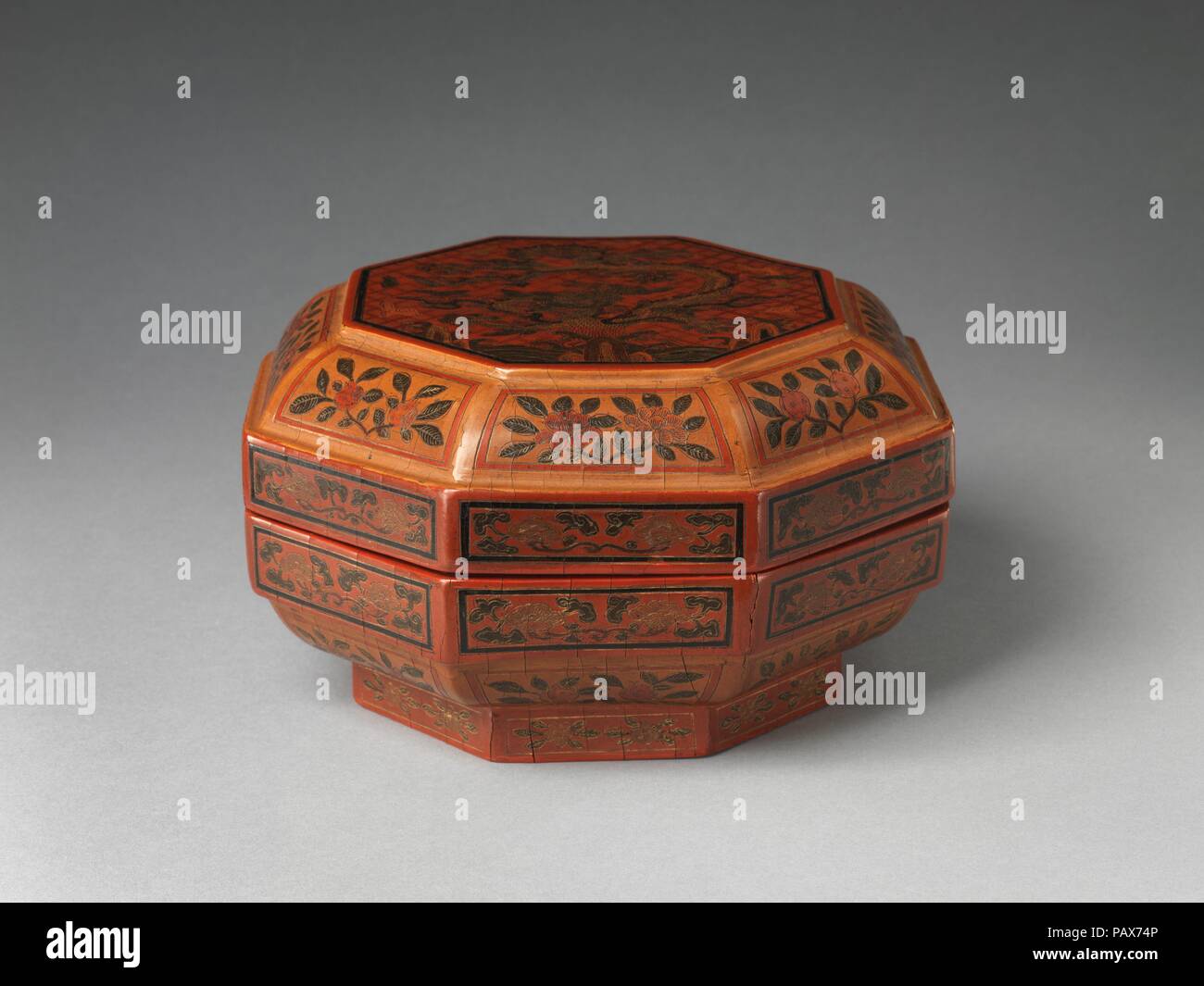 Octagonal box with 'dragon pine'. Culture: China. Dimensions: H. 4 3/4 in. (12.1 cm); Diam. 8 3/4 in.(22.2 cm). Date: dated 1595.  The designer of this box transformed the pine tree, an emblem of longevity, into a fanciful dragon, the symbol of the emperor. This combination was probably used to subtly express a wish that the emperor would live as long as the pine tree. Museum: Metropolitan Museum of Art, New York, USA. Stock Photo