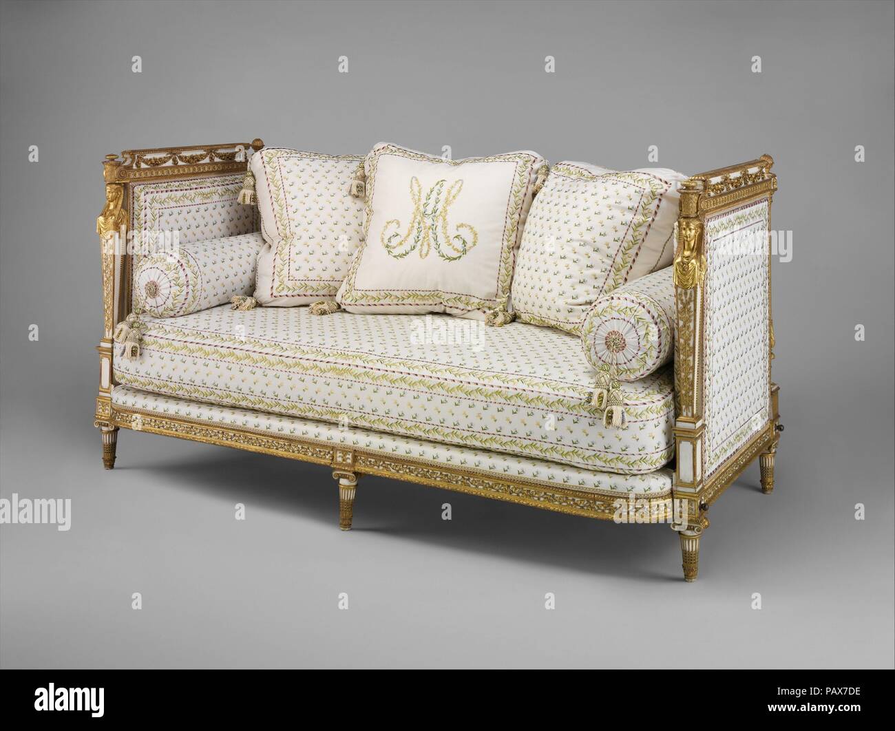 Daybed (Lit de repos or sultane) (part of a set). Culture: French, Paris. Dimensions: H. 36-1/2 x W. 69 x D. 31-1/2 in.  (92.7 x 175.3 x 80.0 cm). Maker: Jean-Baptiste-Claude Sené (1748-1803); painted and gilded by Louis-François Chatard (ca. 1749-1819). Date: 1788.  The Palace of St. Cloud belongs to the Duke of Orleans, is situated on the declivity of a mountain washed by the Seine. . . . The view from the house is delightful.  -- Harry Peckham, A Tour through Holland . . .and Part of France  Louis XVI purchased the country residence of the duc d'Orléans a few miles west of Paris for Marie-A Stock Photo