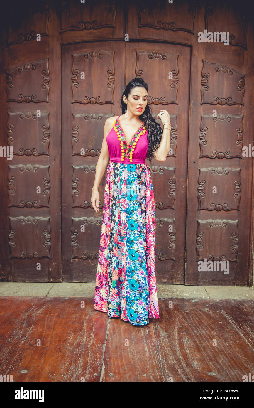 Girl with colorful dress in front of a door Stock Photo - Alamy
