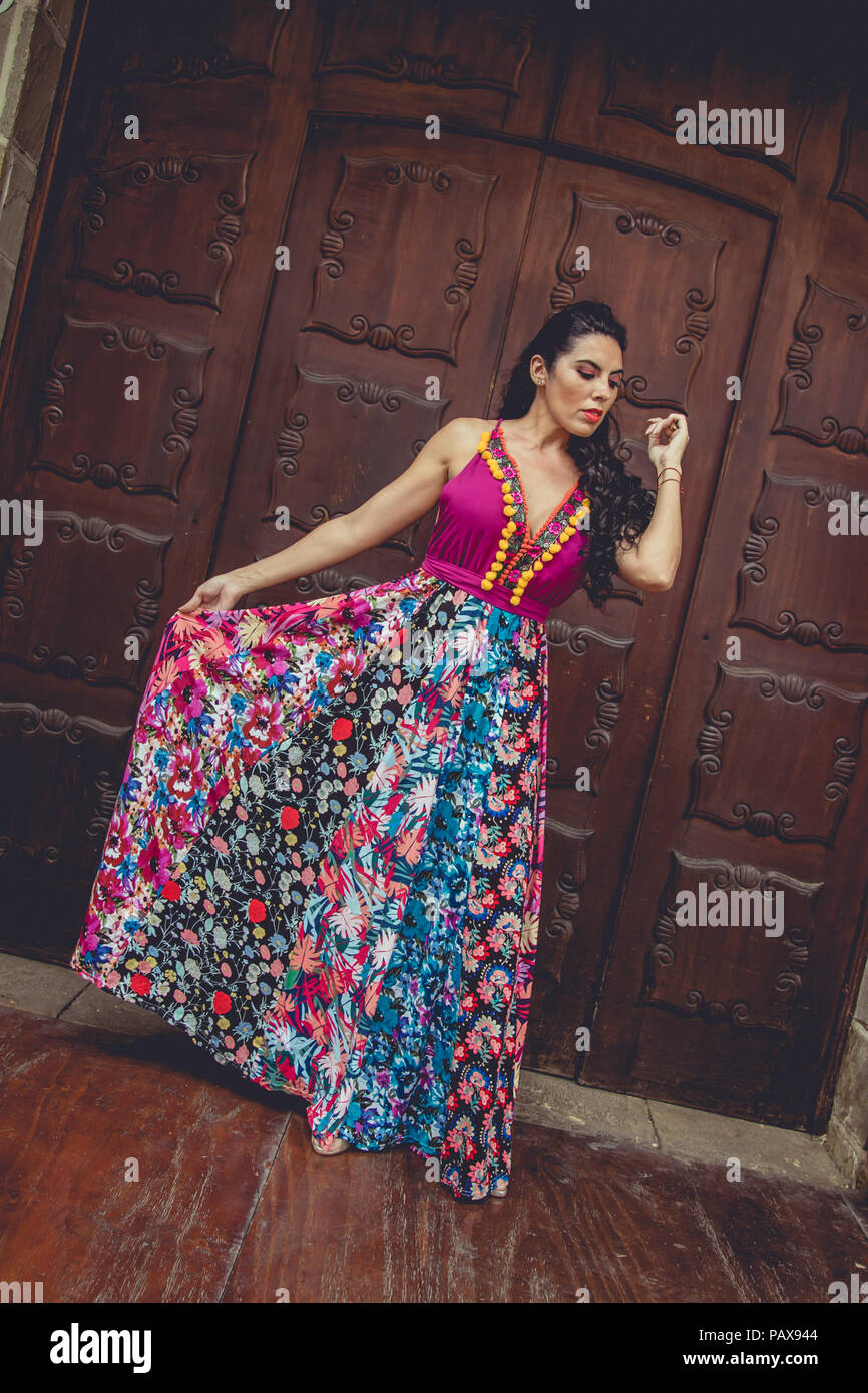 Girl with colorful dress in front of a door Stock Photo - Alamy