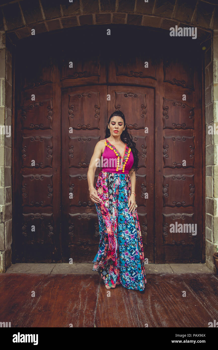 Girl with colorful dress in front of a door Stock Photo - Alamy