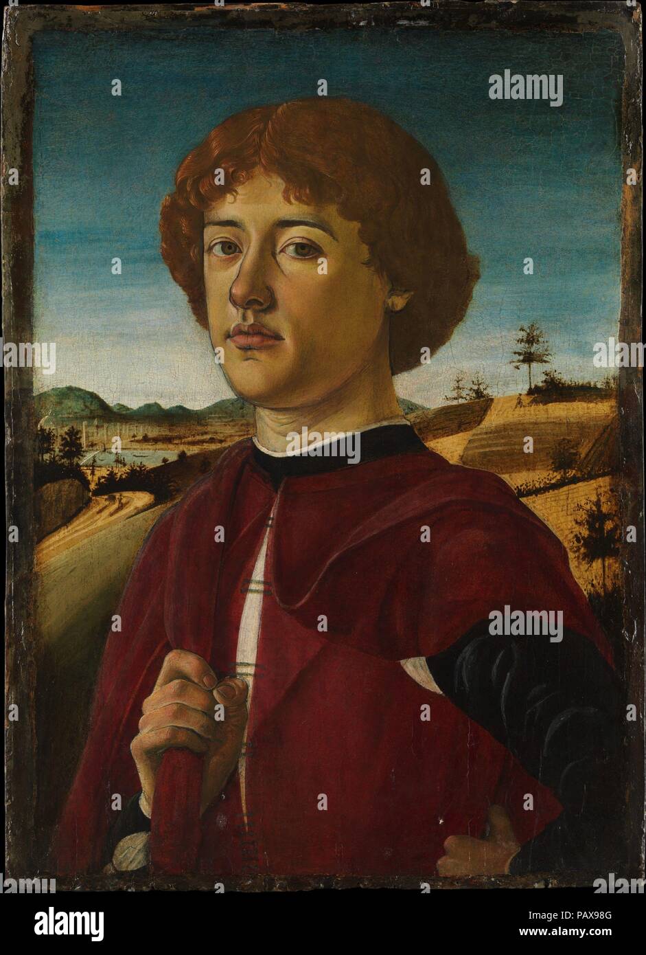 Portrait of a Young Man. Artist: Biagio d'Antonio (Italian, Florentine, active by 1472-died 1516). Dimensions: Overall 21 3/8 x 15 1/2 in. (54.3 x 39.4 cm); painted surface 20 1/4 x 14 1/4 in. (51.4 x 36.2 cm). Date: probably ca. 1470.  This is Biagio d'Antonio's most distinguished portrait, and was painted in around 1470. Its sculptural quality is indebted to the sculptor and painter Verrocchio, who had a deep influence on artists of Biagio's generation. In the background Biagio shows the valley of the Arno river with the city walls and cathedral of Florence. Museum: Metropolitan Museum of Ar Stock Photo