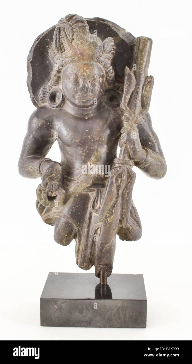 Vajrapani. Culture: India (Kashmir). Dimensions: H. 9 in. (22.9 cm); H. inc. base 10 1/4 in. (26 cm); W. 5 3/8 in. (13.7 cm). Date: late 6th-7th century.  This powerful figurine is best understood as the Mahayana bodhisattva Vajrapani, who appropriated the lighting-bolt scepter (Skt: vajra) of Indra, the Vedic storm god, and repurposed it. Its meaning shifted from that being associated with the life-affirming power of storms (e.g. the monsoons), to the Buddhist savior Vajrapani, who facilitates journeying the path of enlightenment and aiding crystal clear thought as penetrating as a lighting s Stock Photo