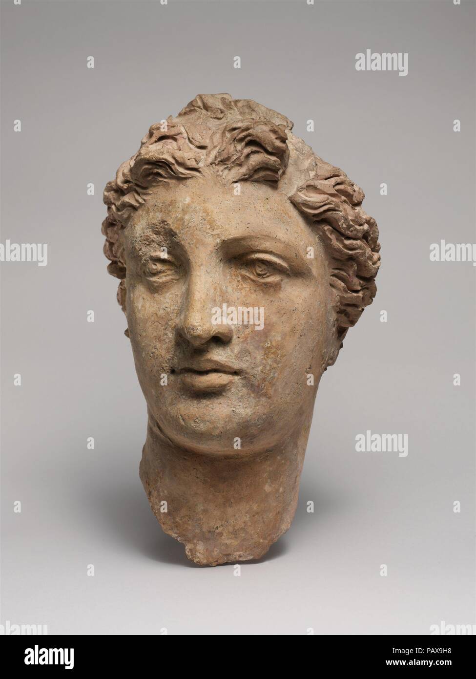 Terracotta head of a woman. Culture: Greek, South Italian, Tarentine. Dimensions: H. 10 1/2 in. (26.7 cm). Date: 3rd-2nd century B.C..  Since fine, hard stone such as marble was not readily available, Tarentine artists used terracotta for large-scale figures of high quality. The work to which this extraordinary head originally belonged may have been associated with a goddess, perhaps Aphrodite. Among the thousands of clay vases and figures found at Tarentum, subjects pertaining to the life of women, and specifically marriage, are prevalent. Museum: Metropolitan Museum of Art, New York, USA. Stock Photo