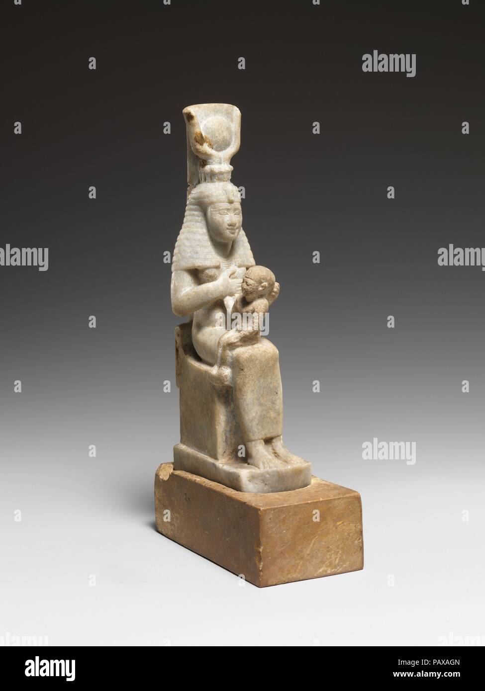 Isis with Horus. Dimensions: H. 19.9 × W. 5.1 × D. 10.4 cm (7 13/16 × 2 × 4 1/8 in.). Date: 332-30 B.C..  Isis with her son Horus seated on her lap is sculpted here in a marble with a distinctive bluish cast. It is notable that dense whitish stones are popular choices for statuettes of the goddess and her son. The statuette fits into a separate ancient base of limestone. Museum: Metropolitan Museum of Art, New York, USA. Stock Photo