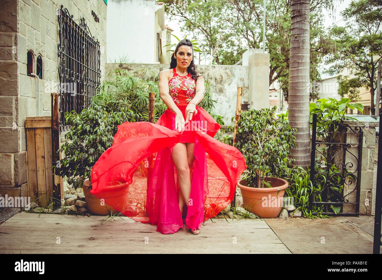 Girl with red dress in garden Stock Photo Alamy