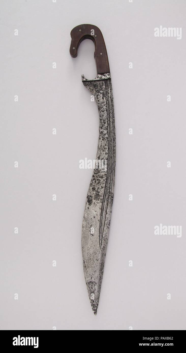 Sword (Falcata). Culture: Iberian. Dimensions: H. 20 15/16 in. (53.2 cm); H. of blade 17 in. (43.2 cm); W. 2 5/8 in. (6.7 cm); D. 13/16 in. (2.1 cm); Wt. 1 lb. 0.7 oz. (473.4 g). Date: 5th to 1st century B.C. and later.  The falcata was a popular type of sword in the Iberian Peninsula from the fifth to the first century B.C. Closely related in form to slashing weapons found in Greece, it is distinguished by the fact that its blade is double-edged for about half of its length, whereas Greek specimens normally have a single cutting edge.  Although its old patina was removed and an inaccurate mod Stock Photo