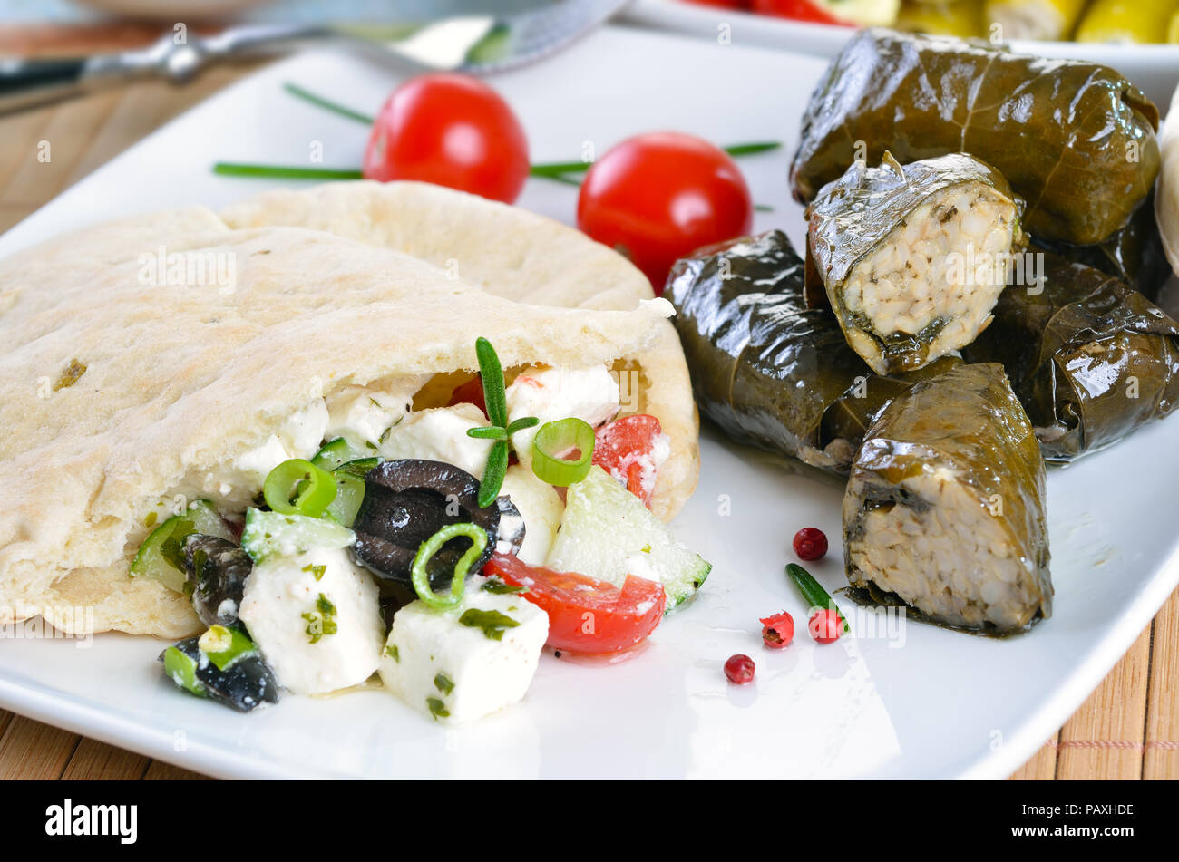 Cold Greek appetizers stuffed flat bread, stuffed vine leaves, sheep's