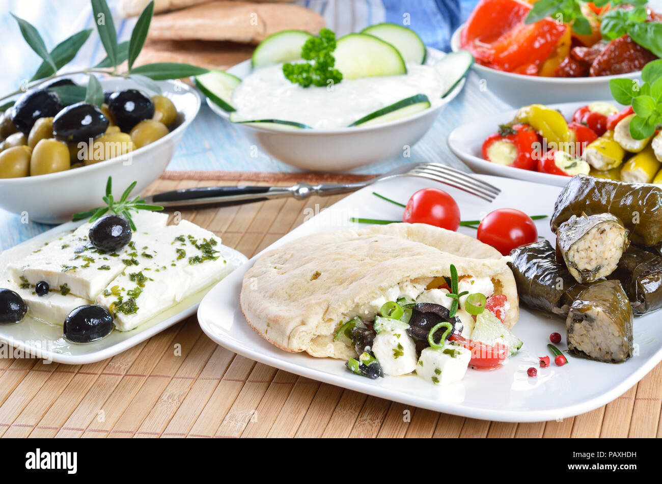 Cold Greek appetizers stuffed flat bread, stuffed vine leaves, sheep's