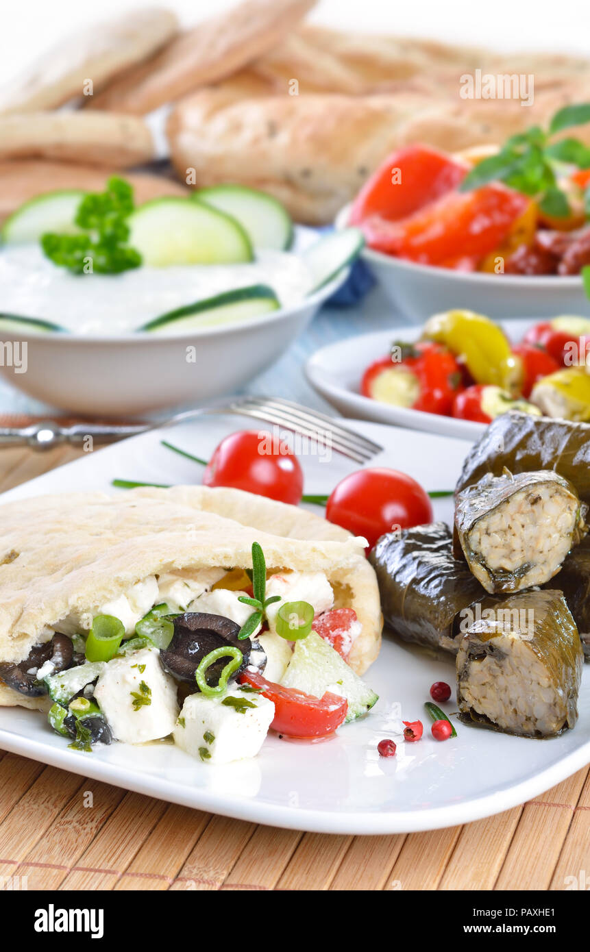 Cold Greek appetizers stuffed flat bread, stuffed vine leaves, sheep's