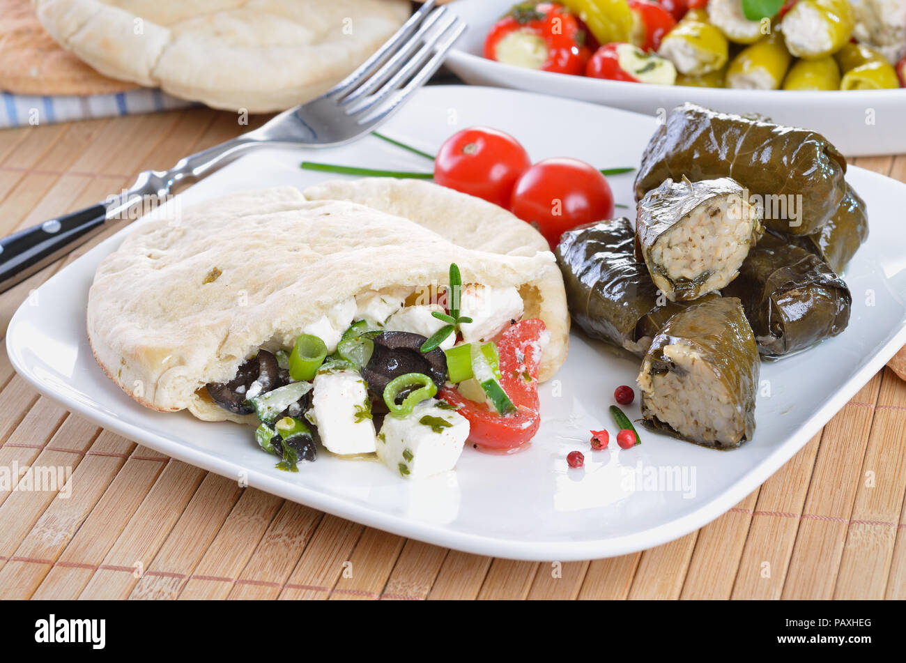 Cold Greek appetizers stuffed flat bread, stuffed vine leaves, sheep's