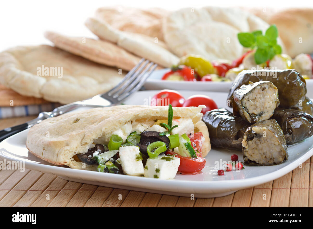 Cold Greek appetizers stuffed flat bread, stuffed vine leaves, sheep's