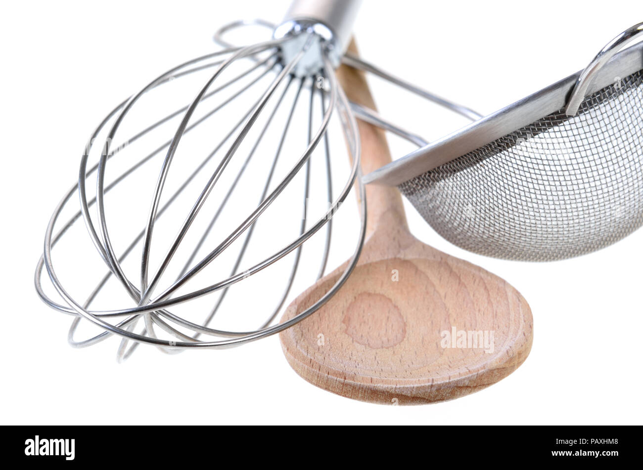 Whisk, wooden spoon, and a colander, isolated Stock Photo Alamy
