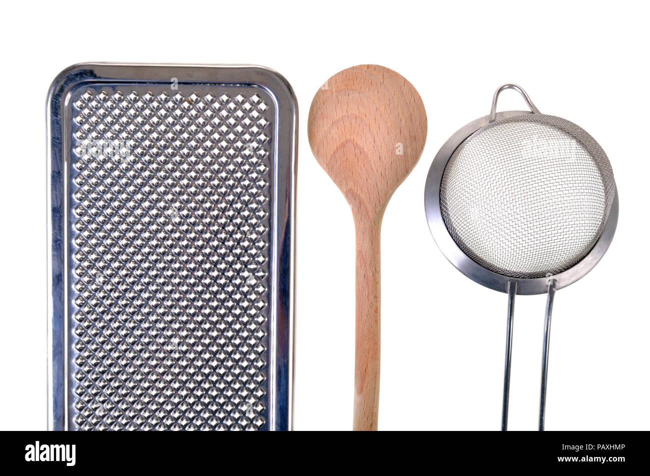 Grater, wooden spoon and a colander, isolated Stock Photo Alamy