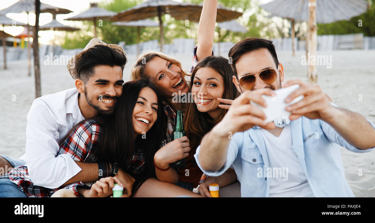 Happy young people taking selfies Stock Photo - Alamy