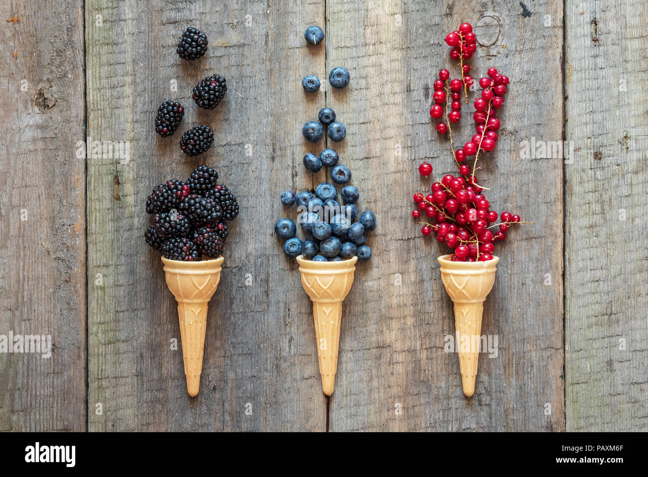 Berries in ice cream cones (blackberry, blueberry, redcurrant). Healthy summer food concept. Stock Photo