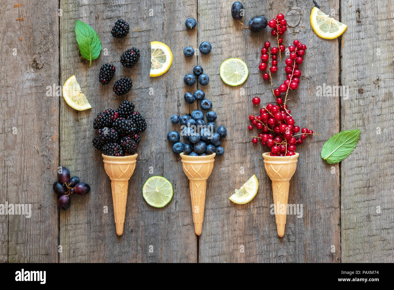 Berries in ice cream cones (blackberry, blueberry, redcurrant). Healthy summer food concept. Stock Photo