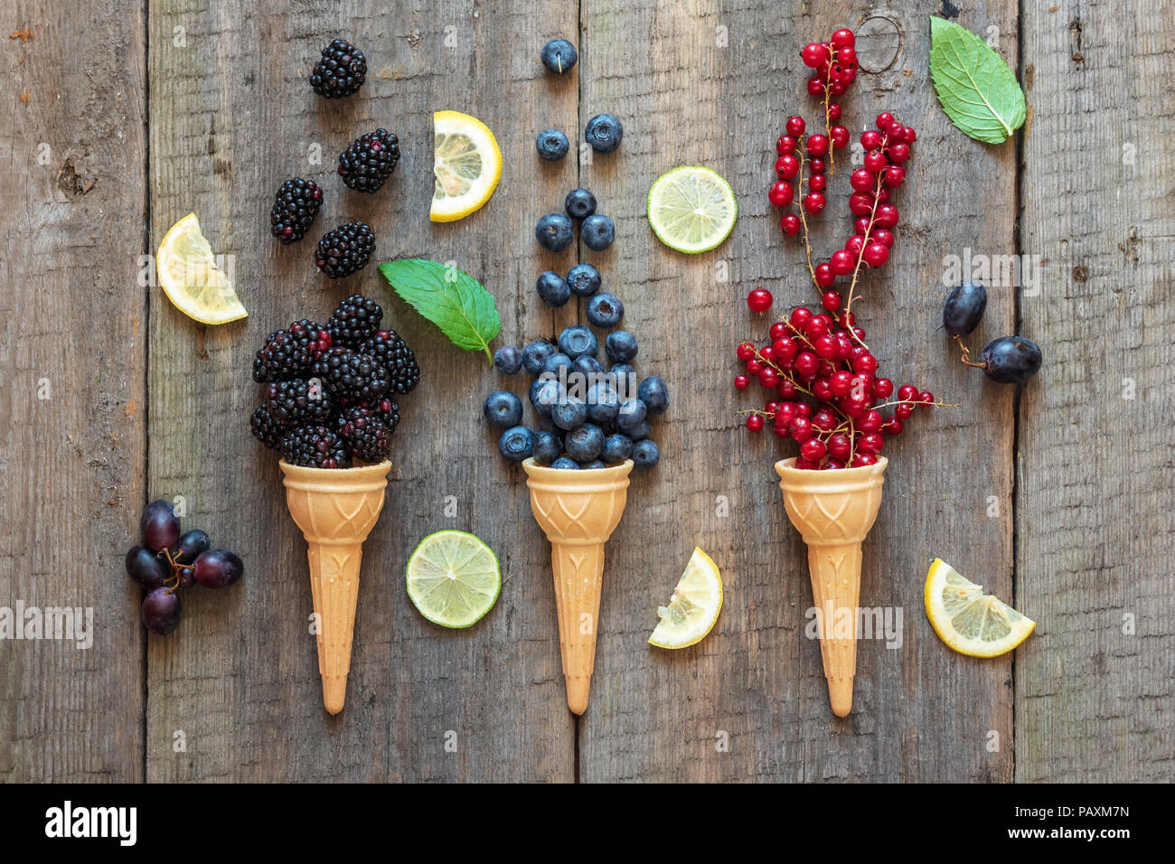 Berries in ice cream cones (blackberry, blueberry, redcurrant). Healthy summer food concept. Stock Photo