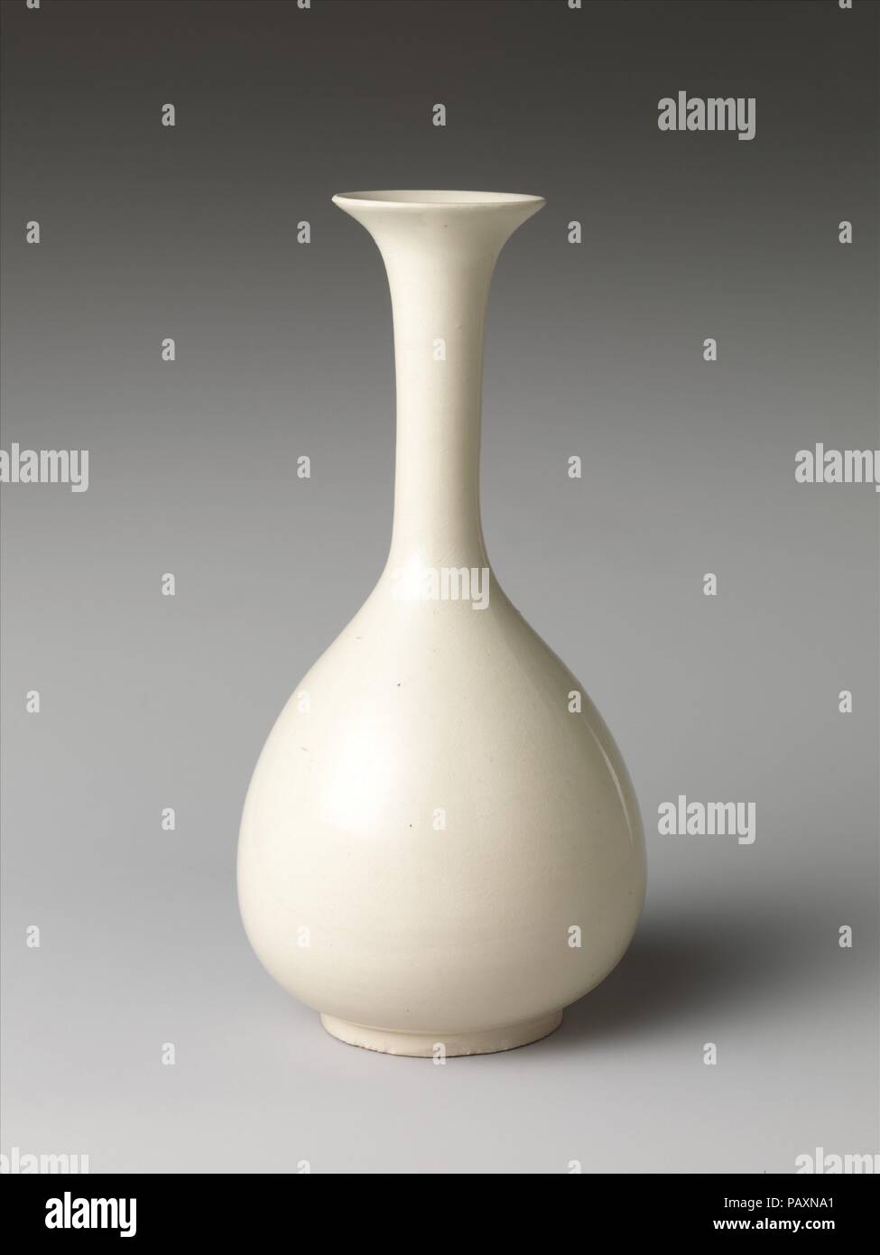 Bottle. Culture: China. Dimensions: H. 9 5/8 in. (24.4 cm); Diam. 4 5/8 in. (11.7 cm). Date: 10th-11th century.  Named after a prefecture in Hebei Province in north China, Ding wares were made from the eighth to the thirteenth or fourteenth century, and were popular at the Northern Song (960-1127) court. The shape of this base, which most likely derives from a silver piece, is extraordinarily difficult to make because the neck is so long and slender. Museum: Metropolitan Museum of Art, New York, USA. Stock Photo