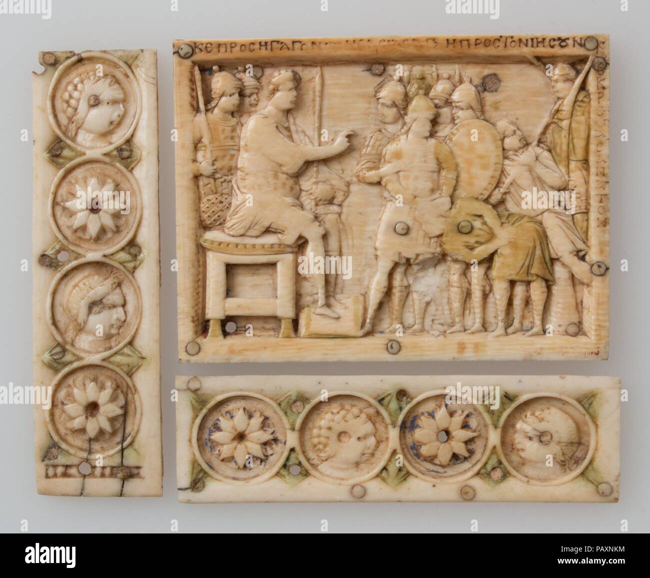 Casket Plaque. Culture: Byzantine. Dimensions: a: 2 9/16 x 3 7/16 x 1/4 in. (6.5 x 8.7 x 0.6 cm)  b: 3 9/16 x 1 x 1/16 in. (9 x 2.5 x 0.2 cm)  c: 1 x 3 1/2 x 1/16 in. (2.6 x 8.9 x 0.2 cm). Date: 900-1000.  These panels are from a casket that illustrated Joshua's conquest of the Promised Land and carry paraphrasings of texts from the Book of Joshua. The first narrative panel, designed to fit a lock plate, shows the capture of the city of Ai and is inscribed, 'And Joshua stretched out his hand toward the city and they rose up quickly and they slew all' (Joshua 8:18-19). The second panel shows th Stock Photo