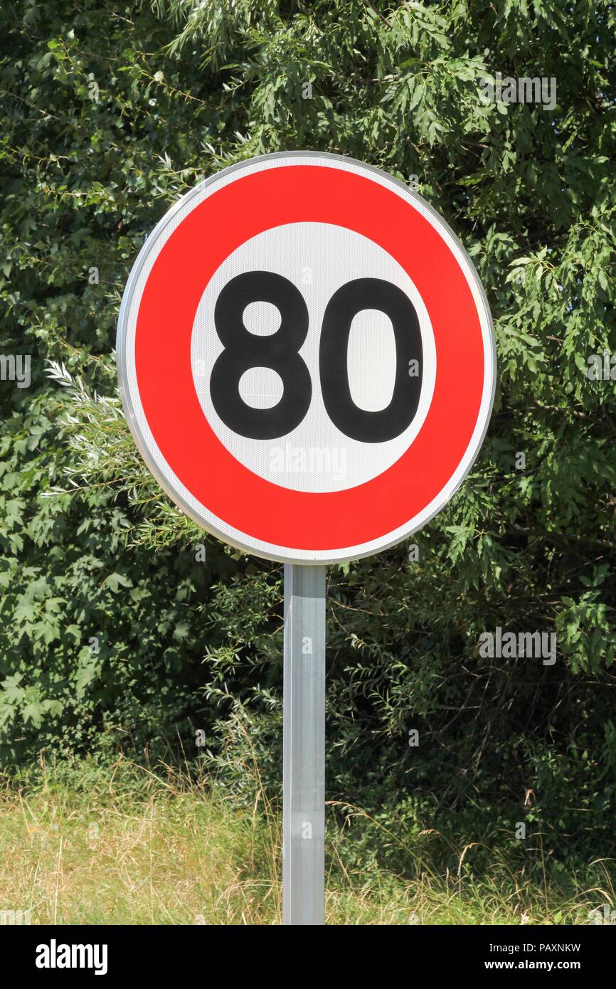 Speed limit traffic sign 80 on the road in France Stock Photo