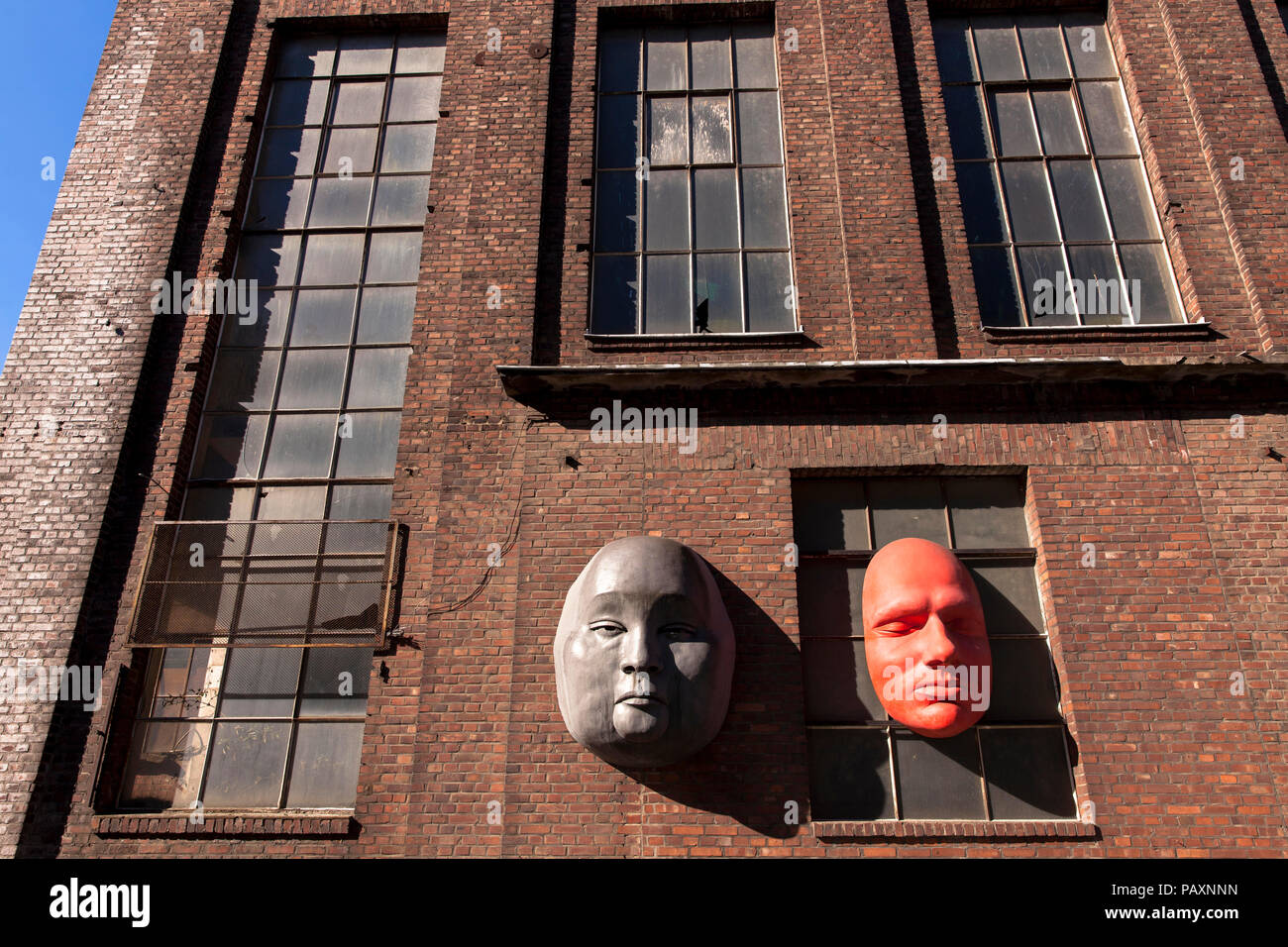 oversized faces on the facade of a building of the former Kloeckner Humboldt Deutz AG in the district Muelheim, Cologne, Germany.  ueberdimensionale G Stock Photo