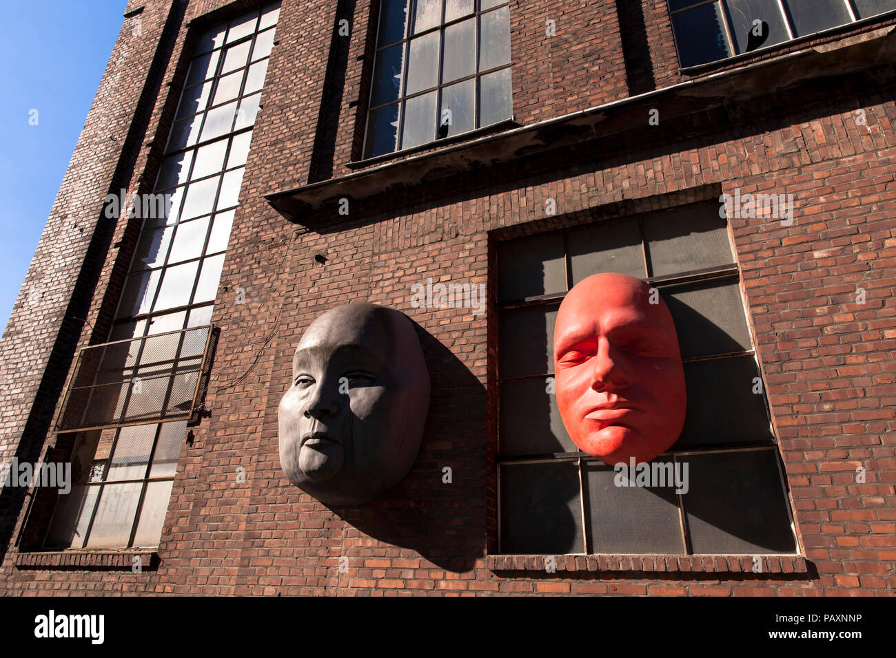 oversized faces on the facade of a building of the former Kloeckner Humboldt Deutz AG in the district Muelheim, Cologne, Germany.  ueberdimensionale G Stock Photo