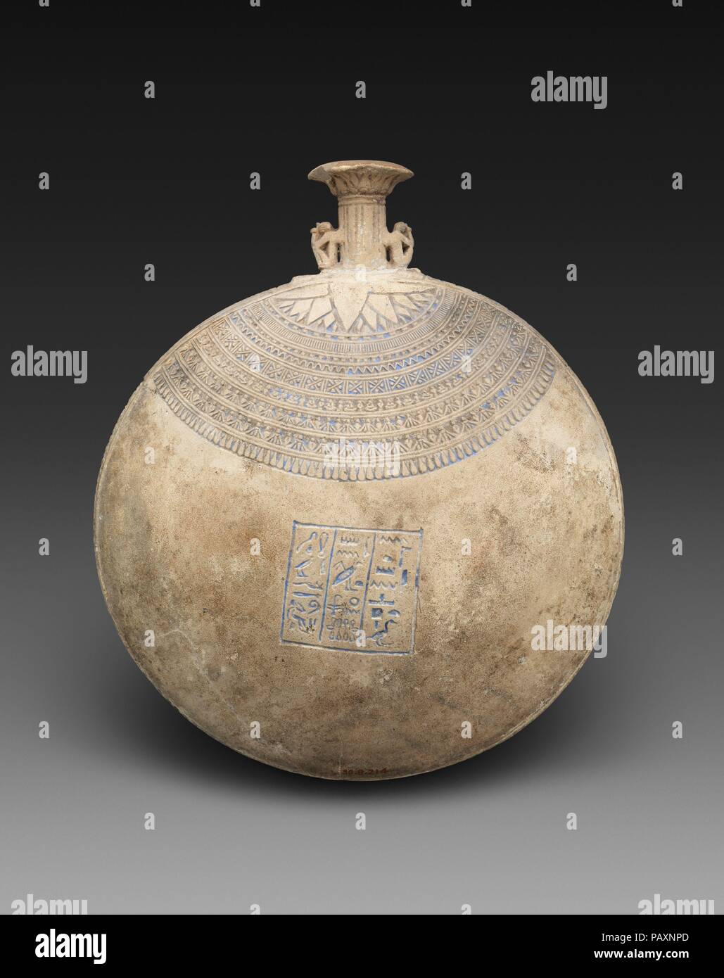 Lentoid Bottle ('New Year's Bottle') inscribed for the God's Father Amenhotep, son of the God's Father Iufaa. Dimensions: H. 21 cm (8 1/4 in); diam. 18 cm (7 1/16 in). Date: 664-525 B.C..  This lentoid flask, inscribed for a priest named Amenhotep, is an example of a New Year's bottle. Filled perhaps with perfume, oil, or water from the Nile, it would have been a gift associated with the celebration of the beginning of the year. Around the shoulders of the vase are incised bands of floral patterns, meant to echo the vegetal collar that would have been worn by a participant in a ceremonial or f Stock Photo